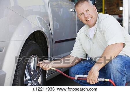 Man Filling Tires on RV View Large Photo Image Stock Image - Man Filling Tires on RV. Fotosearch