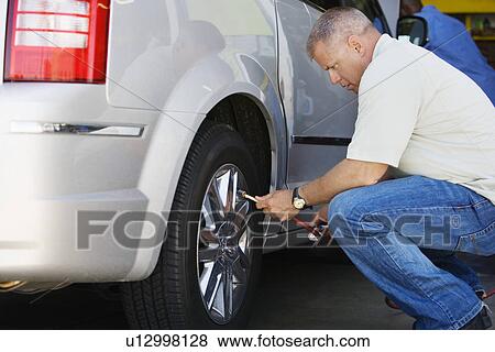 Man Filling Tires on RV View Large Photo Image Stock Photo - Man Filling Tires on RV. Fotosearch