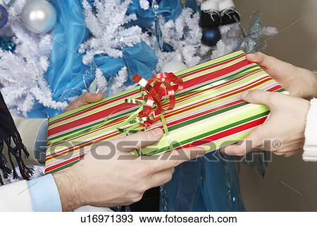 Man handing woman present, close up of hands View Large Photo Image Stock Image - Man handing woman present, close up of hands. Fotosearch