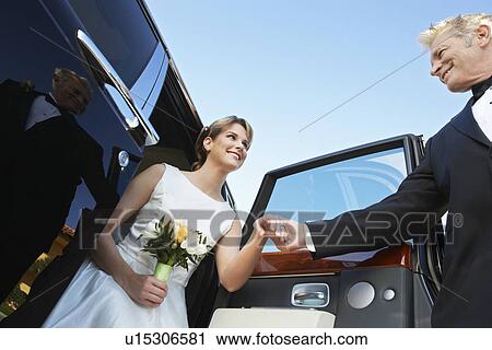 Man helping young woman from limousine View Large Photo Image Stock Image - Man helping young woman from limousine. Fotosearch