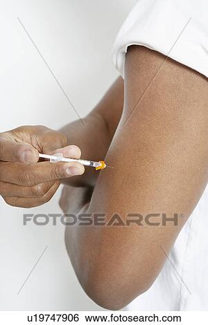 Man injecting insulin using syringe, close-up View Large Photo Image Stock Photograph - Man injecting insulin using syringe, close-up. Fotosearch