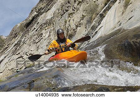 Stock Photography - Man kayaking in mountain river. Fotosearch