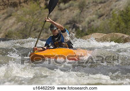 Stock Photo - Man kayaking on mountain river. Fotosearch