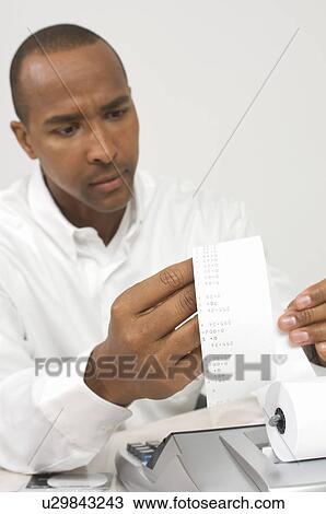 Man Looking at Calculator Tape View Large Photo Image Stock Image - Man Looking at Calculator Tape. Fotosearch