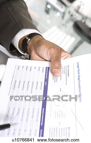 Stock Image - Man Looking at Paper. Fotosearch