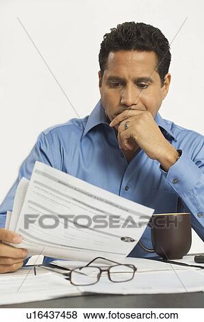 Man Reading a Tax Form View Large Photo Image Stock Photo - Man Reading a Tax Form. Fotosearch
