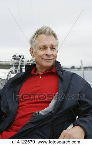 Stock Photo - Man relaxing on yacht, portrait. Fotosearch