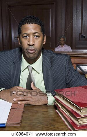 Stock Image - Man sitting in court, portrait. Fotosearch