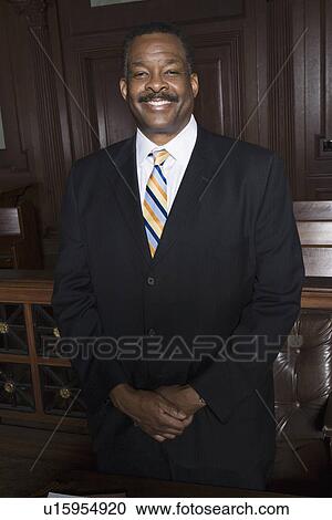 Man standing in court, portrait View Large Photo Image Stock Image - Man standing in court, portrait. Fotosearch