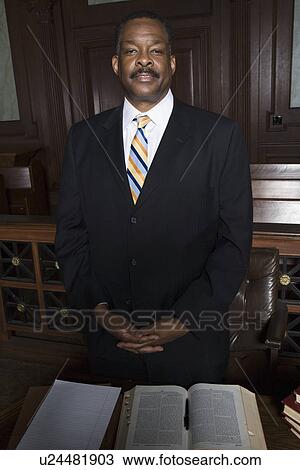Man standing in court, portrait View Large Photo Image Stock Image - Man standing in court, portrait. Fotosearch