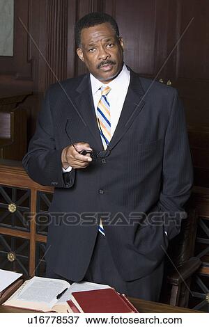 Man standing in court, portrait View Large Photo Image Stock Photo - Man standing in court, portrait. Fotosearch
