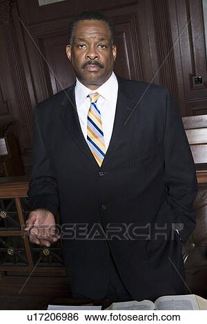 Man standing in court, portrait View Large Photo Image Stock Photograph - Man standing in court, portrait. Fotosearch