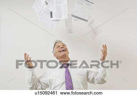 Stock Image - Man Throwing Bills in the Air. Fotosearch