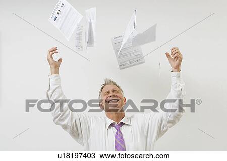 Stock Image - Man Throwing Bills in the Air. Fotosearch