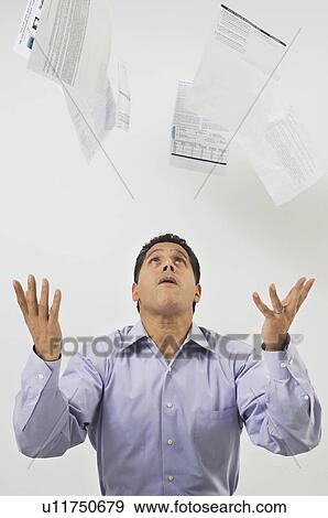 Stock Photo - Man Throwing Tax Forms in the Air. Fotosearch