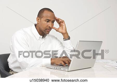 Stock Image - Man Using a Laptop. Fotosearch