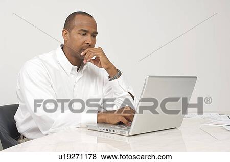 Stock Photo - Man Using a Laptop. Fotosearch