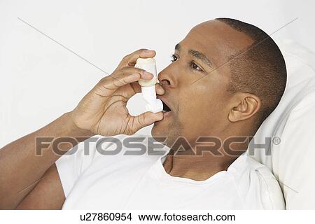 Man using inhaler in hospital bed View Large Photo Image Picture - Man using inhaler in hospital bed. Fotosearch