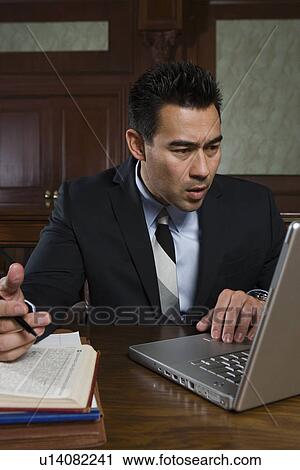 Man using laptop in court View Large Photo Image Stock Image - Man using laptop in court. Fotosearch