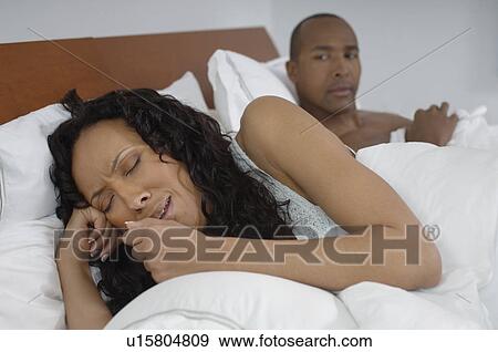 Man watching woman crying in bed View Large Photo Image Stock Photo - Man watching woman crying in bed. Fotosearch