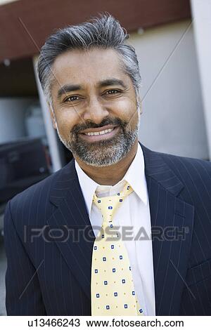 Stock Image - Man wearing suit, outdoors, portrait. Fotosearch