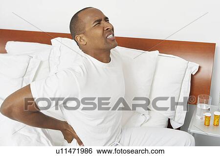 Man with bad back in hospital bed View Large Photo Image Stock Photograph - Man with bad back in hospital bed. Fotosearch