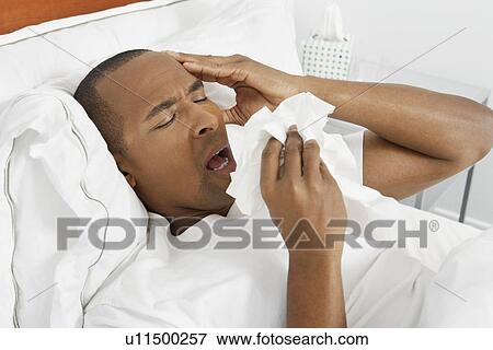 Man with flu in hospital bed View Large Photo Image Stock Photo - Man with flu in hospital bed. Fotosearch