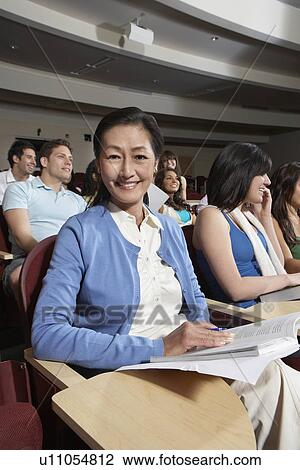 Stock Image - Mature female student in class, portrait. Fotosearch
