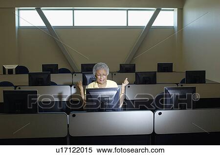 Mature female student working in computer classroom View Large Photo Image Stock Photography - Mature female student working in computer classroom. Fotosearch