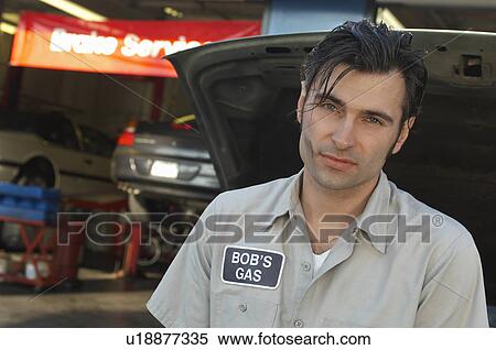 Mechanic by open car hood, portrait View Large Photo Image Stock Photography - Mechanic by open car hood, portrait. Fotosearch