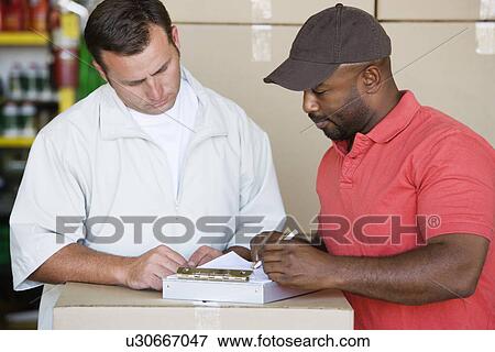 Stock Photo - Mechanic Showing Customer an Invoice. Fotosearch