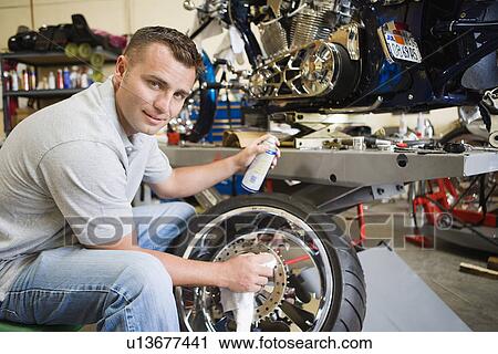 Mechanic Working on a Tire View Large Photo Image Stock Image - Mechanic Working on a Tire. Fotosearch