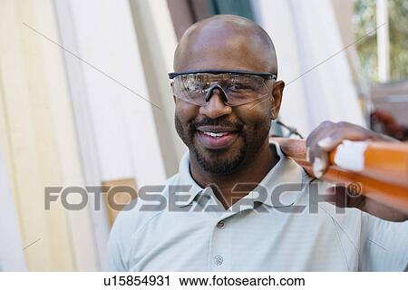 Stock Image - Mid-adult construction worker at work. Fotosearch