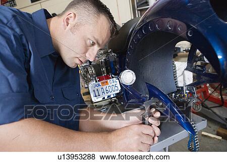 Mid-adult mechanic at work View Large Photo Image Stock Photo - Mid-adult mechanic at work. Fotosearch