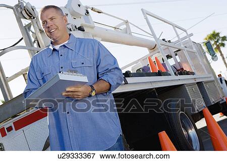 Mid-adult mechanic at work View Large Photo Image Stock Photo - Mid-adult mechanic at work. Fotosearch