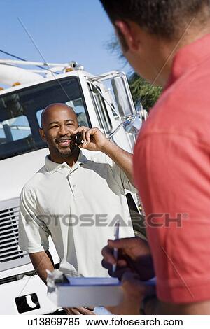 Mid-adult truck driver with co-worker View Large Photo Image Stock Photography - Mid-adult truck driver with co-worker. Fotosearch
