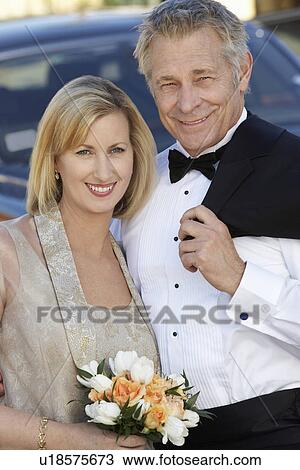Middle-aged couple in formal wear in front of limousine, portrait View Large Photo Image Stock Image - Middle-aged couple in formal wear in front of limousine, portrait. Fotosearch