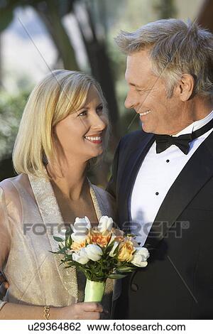 Stock Image - Middle-aged couple in formal wear, portrait. Fotosearch