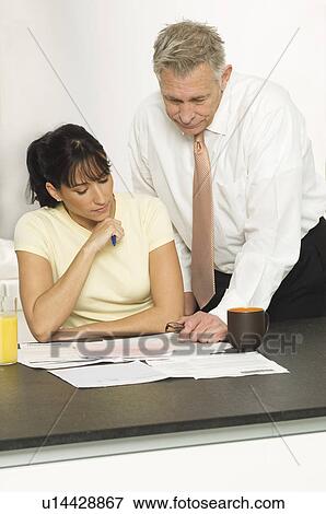 Middle Aged Man Helping Woman with Finances View Large Photo Image Stock Photo - Middle Aged Man Helping Woman with Finances. Fotosearch