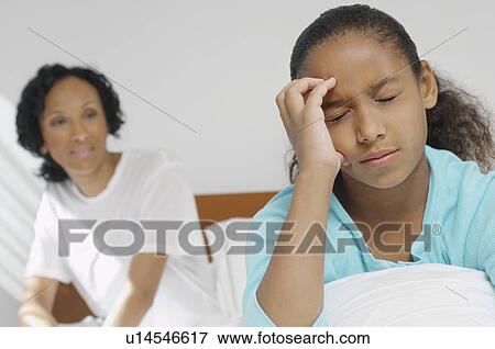 Nurse watching girl (7-9) with migraine in hospital View Large Photo Image Stock Photo - Nurse watching girl (7-9) with migraine in hospital. Fotosearch