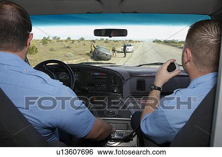 Stock Photograph - Paramedics arriving at car crash scene, view from ambulance. Fotosearch