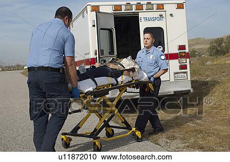Paramedics transporting victim on stretcher View Large Photo Image Stock Image - Paramedics transporting victim on stretcher. Fotosearch