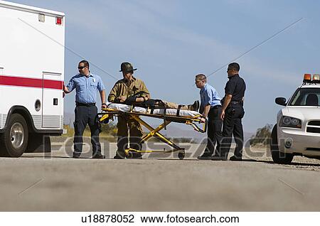 Paramedics transporting victim on stretcher View Large Photo Image Stock Image - Paramedics transporting victim on stretcher. Fotosearch