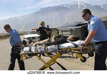 Paramedics transporting victim on stretcher View Large Photo Image Stock Photograph - Paramedics transporting victim on stretcher. Fotosearch