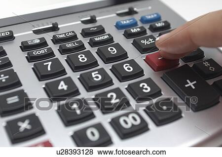 Stock Photo - Person using calculator, close-up of finger. Fotosearch