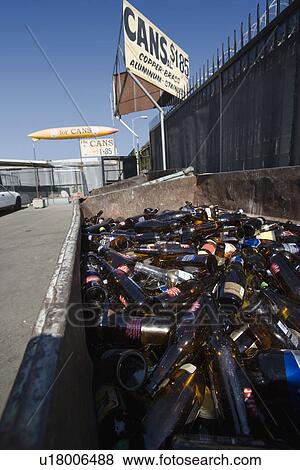 Stock Photo - Pile of glass bottles in bin. Fotosearch