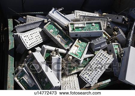 Stock Image - Pile of old electronic components in bin. Fotosearch