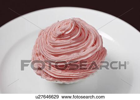 Stock Photo - Pink cupcake on plate. Fotosearch