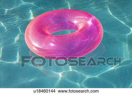 Picture - Pink Float Tube Floating in Swimming Pool. Fotosearch