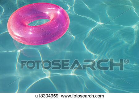 Stock Photo - Pink Float Tube Floating in Swimming Pool. Fotosearch